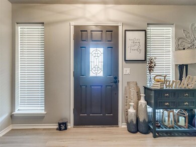 Foyer with wood finished floors and plenty of natural light