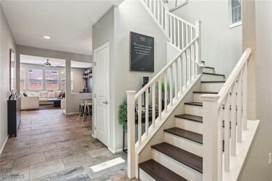 Staircase featuring ceiling fan, baseboards, and r