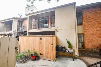 This photo shows a two-story, brick and wood townh