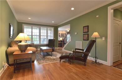 The living room has recessed lighting and nice pla