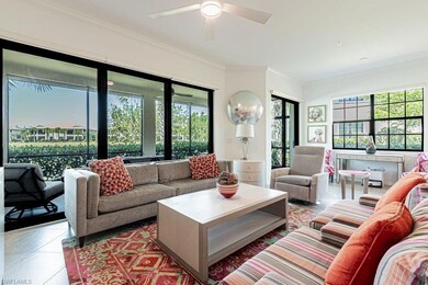 Tiled living room featuring plenty of natural light, ornamental molding, and a ceiling fan