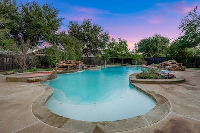 Impressive backyard design with covered patio, pool, and open entertaining spaces.