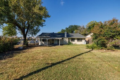 Rear view of property featuring a patio area and a chimney