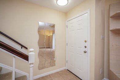This entryway features a white front door, a uniqu