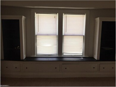 Dining-room with built-ins and a ceiling fan.