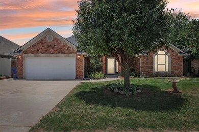 View of front of home with a yard and a garage