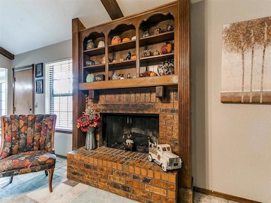 Living area featuring carpet flooring, a fireplace, and a textured wall