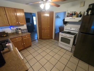 Kitchen featuring white range with electric stovet