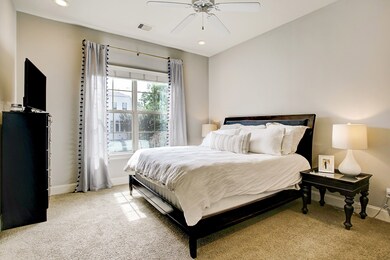 The tranquil primary suite features plush carpetin