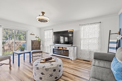 Living room featuring visible vents, light wood-st