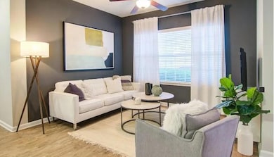 Living room featuring baseboards, wood finished fl