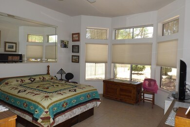 MASTER SUITE W/BAY WINDOW WITH VIEW OF THE GOLF COURSE.