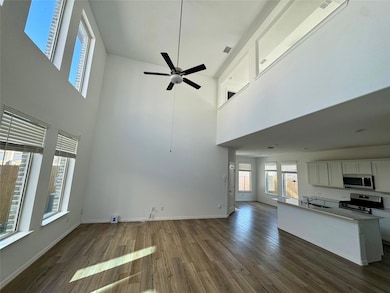 Unfurnished living room with a sink, baseboards, a