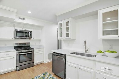 Kitchen with stainless steel appliances, white cabinetry, recessed lighting, light wood-type flooring, and ornamental molding