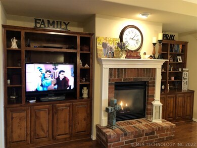 Rich wood built in cabinets and cozy fireplace.