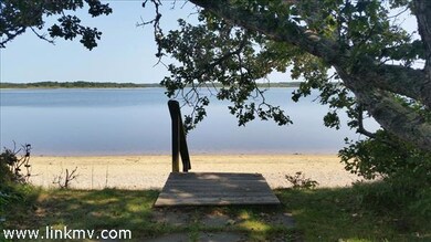 The back yard of this Chilmark property opens onto private beach frontage on Tisbury Great Pond.