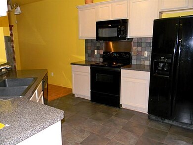 Dual entry Kitchen with all black appliances.