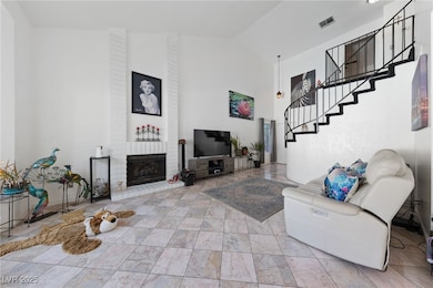 Living room featuring high vaulted ceiling, stairs
