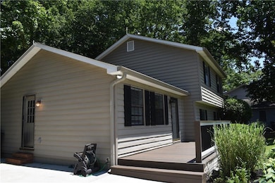 View of side of home featuring a deck and entry steps