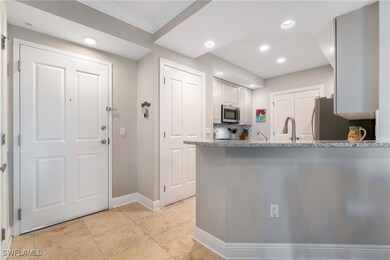 Kitchen with backsplash, white cabinets, ornamenta