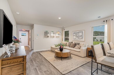 Living room with light wood-style flooring and baseboards