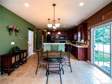 Kitchen has breakfast nook and breakfast bar.
