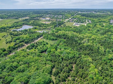 Aerial view of a heavily wooded area and a large body of water