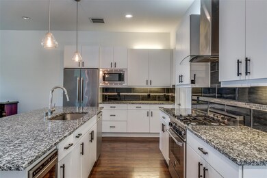 Kitchen featuring stainless steel appliances, wall