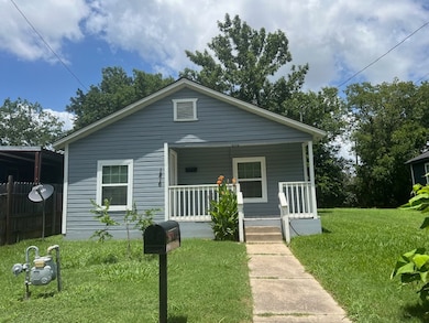 Bungalow-style house with a porch and a front yard