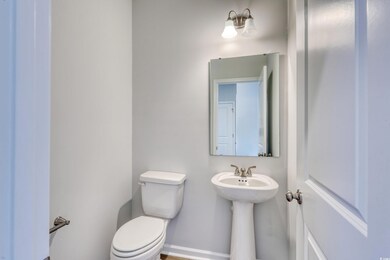 Half bathroom with toilet and baseboards