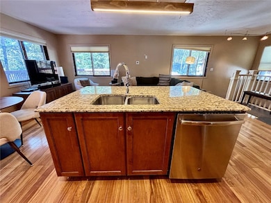 Kitchen featuring open floor plan, a kitchen islan