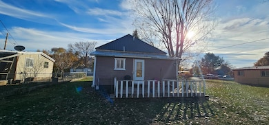 Back of property with a fenced backyard, a metal roof, and a deck