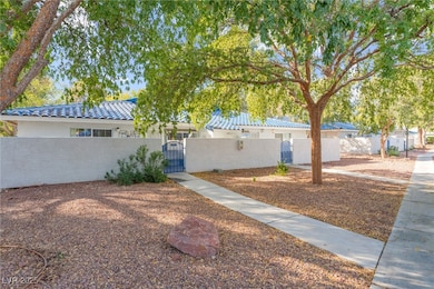 View of front of home featuring a gate, a fenced front yard, a tiled roof, and stucco siding