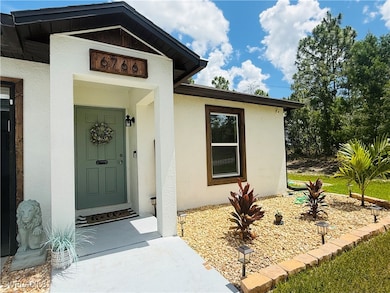 View of exterior entry featuring stucco siding