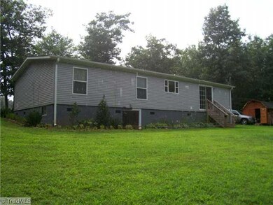 Exterior Back. Rear Veiw of Home with Nice Private Back Yard.  Deer visit often.  The home has vinyl siding, Insulated windows, block foundation properly vented, block piers, moisture barrier and tie downs.  Roof is approximately 6 years old.