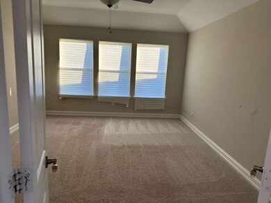 Spare room featuring light carpet, a ceiling fan, and lofted ceiling