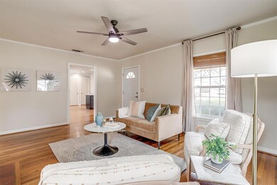 Living area featuring baseboards, light wood-style