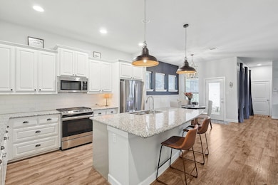 Kitchen featuring light wood-style floors, a cente