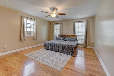 Spacious primary with real wood floors.