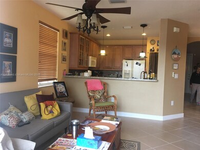 Family room and kitchen with wood kitchen cabinets