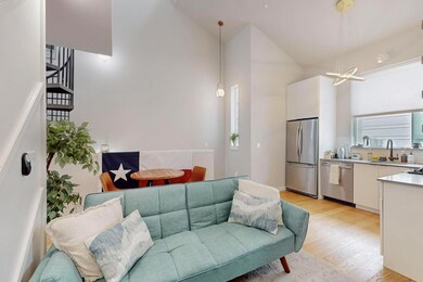 Living area with light wood finished floors, a ch