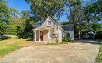 View of outdoor structure featuring concrete driveway and covered porch