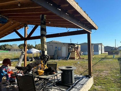 View of patio featuring a playground and an outdoor structure