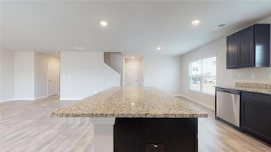 Kitchen featuring a kitchen island, visible vents,