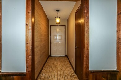 Entryway featuring wood walls