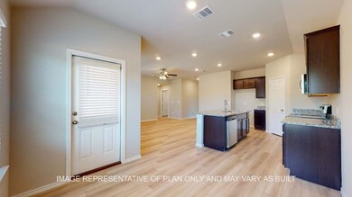 Kitchen with light stone counters, light wood finished floors, recessed lighting, a kitchen island with sink, and open floor plan