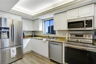 White cabinetry, granite counters, stainless appliances.