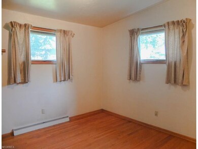 Bedroom 2 with wood flooring.