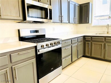 Kitchen with stainless steel appliances, a sink, l