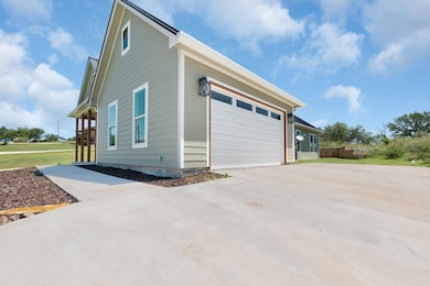 View of side of home featuring a garage, concrete